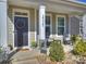 Inviting front porch featuring a welcoming wreath, rocking chairs and fresh spring plants at 2025 Sweet Magnolia Ln, Clover, SC 29710