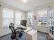 Light-filled home office with a modern desk setup and large windows offering bright natural light at 2025 Sweet Magnolia Ln, Clover, SC 29710