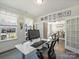 Spacious office with dual work stations and double doors, flowing into an elegant dining room at 2025 Sweet Magnolia Ln, Clover, SC 29710