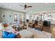Open-concept living room with a view into the kitchen and a large sectional sofa at 2025 Sweet Magnolia Ln, Clover, SC 29710