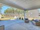 Covered patio with comfortable seating, offering a relaxing outdoor space with views of the fenced backyard at 2025 Sweet Magnolia Ln, Clover, SC 29710