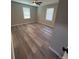 Bedroom with a ceiling fan, hardwood floors, and two windows at 203 Blanche Ave, Belmont, NC 28012