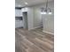An empty dining room with hardwood floors, a modern chandelier, and neutral walls at 203 Blanche Ave, Belmont, NC 28012