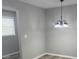 A dining room featuring a modern chandelier, neutral walls, and a window with blinds at 203 Blanche Ave, Belmont, NC 28012