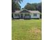 Charming one-story home with a welcoming front porch and a well-manicured lawn at 203 Blanche Ave, Belmont, NC 28012