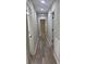 Hallway with gray walls, hardwood floors, and neutral doors at 203 Blanche Ave, Belmont, NC 28012