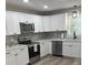 Well-appointed kitchen with stainless steel appliances and white cabinets at 203 Blanche Ave, Belmont, NC 28012