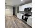 Bright kitchen with stainless steel appliances, white cabinets, and modern finishes at 203 Blanche Ave, Belmont, NC 28012