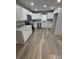 Modern kitchen features white cabinets, stainless steel appliances, and wood-look floors at 203 Blanche Ave, Belmont, NC 28012