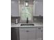 Modern kitchen sink with stainless steel appliances and white cabinets at 203 Blanche Ave, Belmont, NC 28012