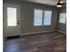 Cozy living room with lots of natural light, wood-look floors, and a ceiling fan at 203 Blanche Ave, Belmont, NC 28012