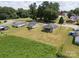Aerial view of a property featuring multiple homes, green fields, and a surrounding neighborhood at 204 13Th St, Belmont, NC 28012