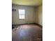 Bedroom showcasing hardwood floors and a window, needing renovation at 204 13Th St, Belmont, NC 28012