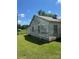 Side view of home with peeling paint and some greenery, needing some TLC at 204 13Th St, Belmont, NC 28012