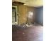 Interior living room featuring wood paneling and floors in disrepair at 204 13Th St, Belmont, NC 28012