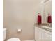 Cozy half bath with neutral paint, and granite countertops at 216 S Clarkson St # E, Charlotte, NC 28202