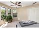 Cozy bedroom with large windows, ceiling fan, closet, and carpet flooring at 216 S Clarkson St # E, Charlotte, NC 28202