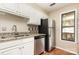 Well-lit kitchen with white cabinets, stainless steel appliances, and granite countertops at 216 S Clarkson St # E, Charlotte, NC 28202