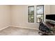 Well-lit office space with carpet, natural light from two windows, and a modern desk setup at 216 S Clarkson St # E, Charlotte, NC 28202