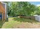 Large, shady backyard featuring mature trees and a privacy fence, perfect for outdoor enjoyment at 219 Lee St, Fort Mill, SC 29715