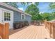 Side view of a wood deck, with a dining table, grill, and access to the home's side entrance at 219 Lee St, Fort Mill, SC 29715