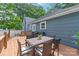 Home's wooden deck features an outdoor dining table, grill, and overlooks the backyard at 219 Lee St, Fort Mill, SC 29715