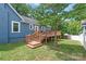 Back of a two-story blue home with a wooden deck and stairway access at 219 Lee St, Fort Mill, SC 29715