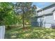 View of the home's side exterior with a lush tree, shed, and a partial view of the backyard at 219 Lee St, Fort Mill, SC 29715