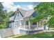 Charming two-story blue home with a welcoming front porch and fenced yard at 219 Lee St, Fort Mill, SC 29715
