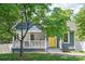 Charming blue home featuring a bright yellow front door, porch, and well-maintained lawn at 219 Lee St, Fort Mill, SC 29715