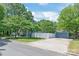 Inviting curb appeal with a charming home featuring a well-maintained lawn, long driveway, and a shed at 219 Lee St, Fort Mill, SC 29715
