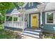 Inviting home entrance with a yellow door, covered porch, and a charming mailbox at 219 Lee St, Fort Mill, SC 29715