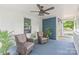 Inviting covered front porch with stylish furniture, ceiling fan, and view to the outside at 219 Lee St, Fort Mill, SC 29715