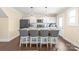 Stylish kitchen with an island, barstool seating and modern pendant lighting fixtures at 219 Lee St, Fort Mill, SC 29715