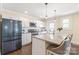 Modern kitchen with stainless steel appliances, granite countertops, and a large island with seating at 219 Lee St, Fort Mill, SC 29715