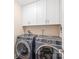 Laundry room featuring front load washer and dryer with overhead cabinets at 219 Lee St, Fort Mill, SC 29715