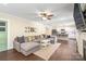Open-concept living room with a large sectional sofa, ceiling fan, and access to the kitchen at 219 Lee St, Fort Mill, SC 29715