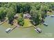 An aerial view of the lakeside property with multiple docks and lush green surroundings at 230 Shady Cove Rd, Troutman, NC 28166