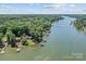 Lakeside property featuring boat docks, private lake access, and a tree-lined perimeter at 230 Shady Cove Rd, Troutman, NC 28166