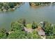 Waterfront home showcasing a spacious lot, lush landscaping, and a private dock on the serene lake at 230 Shady Cove Rd, Troutman, NC 28166