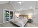 Bright bedroom features a woven headboard, neutral decor and sliding doors that lead to the outside at 230 Shady Cove Rd, Troutman, NC 28166