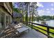 Enjoy waterfront living on this spacious deck with lake views and outdoor seating at 230 Shady Cove Rd, Troutman, NC 28166