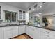 Bright kitchen boasts white cabinetry, dark granite countertops, and stainless steel appliances at 230 Shady Cove Rd, Troutman, NC 28166
