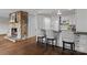 Kitchen breakfast bar with seating near stone fireplace and white kitchen appliances at 230 Shady Cove Rd, Troutman, NC 28166