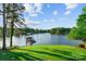 Lake view from grassy lawn, looking toward the wooden dock and boat slip at 230 Shady Cove Rd, Troutman, NC 28166