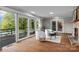 Spacious living room featuring hardwood floors, fireplace, and sliding glass doors to outdoor balcony at 230 Shady Cove Rd, Troutman, NC 28166