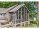 Large screened porch with ample seating for enjoying the outdoors while being protected from insects at 230 Shady Cove Rd, Troutman, NC 28166