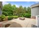Backyard patio featuring stone fire pit and mature landscaping at 230 Shag Bark Ln, Salisbury, NC 28146