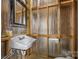 Rustic half bathroom features exposed wall studs and modern fixtures at 230 Shag Bark Ln, Salisbury, NC 28146