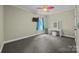 Bright bedroom with gray carpet, ceiling fan, and a vanity near the window at 230 Shag Bark Ln, Salisbury, NC 28146